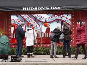 Toronto onlookers pass the flagship Hudson's Bay Store on Queen Street East and Yonge Street, to admire the special Holiday window displays, Dec. 5, 2019. (Stan Behal/Toronto Sun/Postmedia Network)