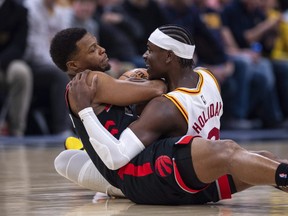 Indiana Pacers guard Aaron Holiday (right) and Toronto Raptors guard Kyle Lowry battle for the ball on Monday night in Indianapolis.