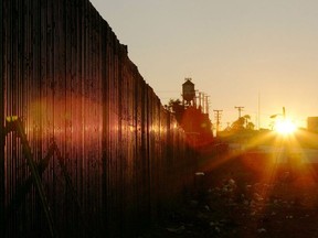 The U.S.-Mexico border fence is seen at sunrise March 25, 2005 near Calexico, California.