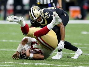 San Francisco 49ers quarterback Jimmy Garoppolo is sacked by New Orleans Saints strong safety Vonn Bell in New Orleans, La., on Dec. 8, 2019.