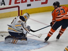 Edmonton Oilers Riley Sheahan scores his first goal as an Oiler on Buffalo Sabres goalie Linus Ullmark  during NHL action at Rogers Place in Edmonton, Dec. 8, 2019.