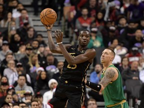 Raptors forward Chris Boucher passes the ball away from Boston Celtics forward Daniel Theis  in the second half at Scotiabank Arena.