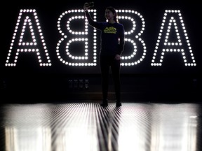 A staff member takes a selfie in front of an ABBA sign during the ABBA: Super Troupers The Exhibition at the O2 in London, December 5, 2019. (REUTERS/Lisi Niesner)
