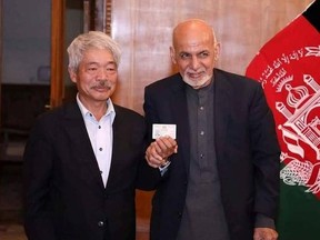 Afghanistan's President Ashraf Ghani and Japanese doctor Tetsu Nakamura pose for a photo, in this undated picture, in Kabul, Afghanistan. Afghan Presidential Palace/Handout via REUTERS THIS IMAGE HAS BEEN SUPPLIED BY A THIRD PARTY. NO RESALES. NO ARCHIVES ORG XMIT: KAB13