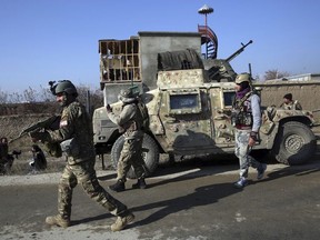 Security personnel arrive near the site of an attack near the Bagram Air Base In Parwan province of Kabul, Afghanistan, Wednesday, Dec. 11, 2019.