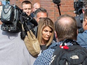 Actress Lori Loughlin  and husband Mossimo Giannulli exit the Boston Federal Court house after a pre-trial hearing with Magistrate Judge Kelley at the John Joseph Moakley US Courthouse in Boston on August 27, 2019.