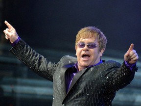 In this file photo taken on June 30, 2012 British singer Elton John performs during his charity concert at the Euro 2012 football championships fanzone, in Kiev. - British rock legend Elton John says Watford football club were his unlikely saviour as he experienced the "worst period of my life" in the 1980's.
