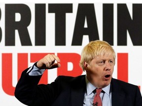 Britain's Prime Minister Boris Johnson reacts as he launches a Conservative Party general campaign poster at the Kent Showground in Detling, southeast England on December 6, 2019.