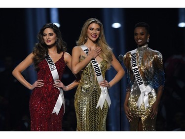 (L-R) Miss Mexico Sofia Aragon, Miss Puerto Rico Madison Anderson and Miss South Africa Zozibini Tunzi stand on stage during the 2019 Miss Universe pageant at the Tyler Perry Studios in Atlanta, Ga., on Dec. 8, 2019.
