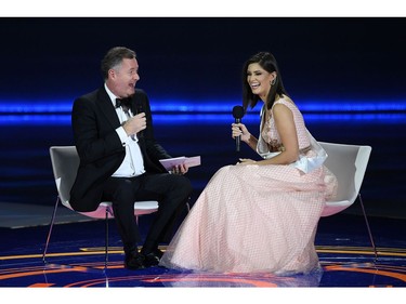 TV presenter Piers Morgan (L) interviews Miss Brazil Elis Coelho during the the Miss World Final 2019 at the Excel arena in east London on Dec. 14, 2019.