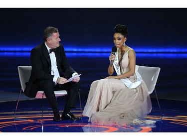 TV presenter Piers Morgan (L) interviews Miss France Ophely Mezino during the the Miss World Final 2019 at the Excel arena 
in east London on Dec. 14, 2019.