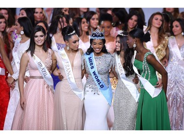 Newly crowned Miss World 2019 Miss Jamaica Toni-Ann Singh (C) smiles with her runners-up during the Miss World Final 2019 at the Excel arena in east London on Dec. 14, 2019.