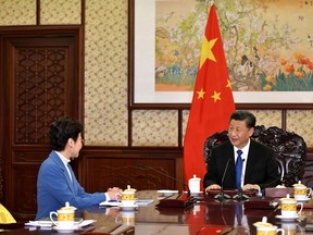 This handout photograph taken and released by the Hong Kong Government on December 16, 2019 shows Chinese President Xi Jinping (R) speaking with Hong Kong Chief Executive Carrie Lam during her annual duty visit, in Beijing.