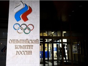 In this file photograph taken on December 9, 2019, a pedestrian walks out of the Russian Olympic Committee (ROC) headquarters in Moscow. - Russia's anti-doping agency will formally contest the country's four-year ban from sporting events over doping violations, the head of the body's supervisory board said on December 19, 2019.