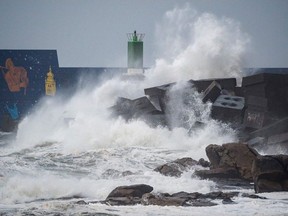 Waves hit the jetty of the port of A Guarda, northwestern Spain, during the storm Fabien, on December 21, 2019.
