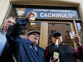 People celebrate winning the first prize of Spain's Christmas lottery "El Gordo" (the Fat One) at the Aragones Center "El Cachirulo" in Reus on December 22, 2019.