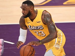Los Angeles Lakers forward LeBron James dribbles the ball during a Christmas Day National Basketball Association (NBA) match-up between the Los Angeles Clippers and Los Angeles Lakers at the Staples Center in Los Angeles, California on December 25, 2019.