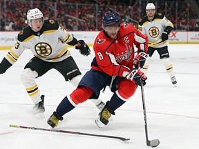 Alex Ovechkin of the Washington Capitals skates with the puck past Charlie McAvoy of the Boston Bruins at Capital One Arena on December 11, 2019 in Washington. (Patrick Smith/Getty Images)