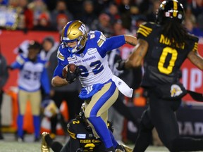 Winnipeg Blue Bombers Drew Wolitarsky avoids a tackle by Tunde Adeleke during the 107th Grey Cup CFL championship football game in Calgary on Sunday, Nov. 24, 2019.