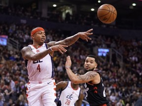 Washington Wizards guard Isaiah Thomas passes the ball as Toronto Raptors guard Fred VanVleet defends at Scotiabank Arena.