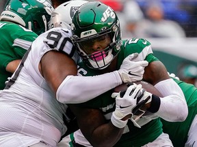 New York Jets running back Le'Veon Bell is stopped by Oakland Raiders defensive tackle Johnathan Hankins (90) at MetLife Stadium. (Robert Deutsch-USA TODAY Sports)