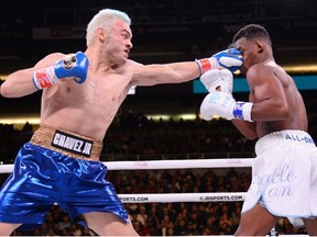 Julio Cesar Chavez Jr (blue trunks) and Daniel Jacobs (white trunks) box during their super middleweight bout at Talking Stick Resort Arena. Jacobs won via fifth round TKO after Chavez quit in his corner.