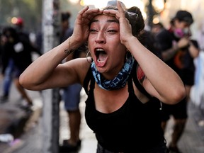 A demonstrator reacts during a protest against Chile's government in Santiago, Chile December 20, 2019. (REUTERS/Pablo Sanhueza)