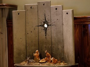 An artwork dubbed "scar of Bethlehem" by street artist Banksy is displayed in the Walled Off hotel, in Bethlehem in the Israeli-occupied West Bank December 22, 2019.