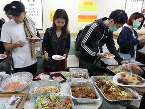 Protesters queue for a free Christmas dinner offered by a local restaurant in Hong Kong, China, Dec. 25, 2019.