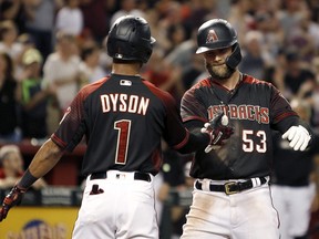 Arizona Diamondbacks' Christian Walker (53) is congratulated by teammate Jarrod Dyson (1) as he crosses the plate against the San Diego Padres Saturday, Sept. 28, 2019, in Phoenix. (AP Photo/Ralph Freso)