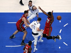 Luka Doncic of the Dallas Mavericks hurts his ankle in the first half against the Miami Heat at American Airlines Center on Dec.14, 2019 in Dallas, Texas.