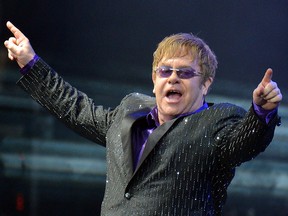 In this file photo taken on June 30, 2012 singer Elton John performs during his charity concert at the Euro 2012 football championships fanzone, in Kiev. (SERGEI SUPINSKY/AFP via Getty Images)