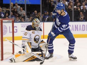 Buffalo Sabres goalie Carter Hutton makes a save on Toronto Maple Leafs forward Pierre Engvall on Saturday night at Scotiabank Arena. (Dan Hamilton/USA TODAY Sports)