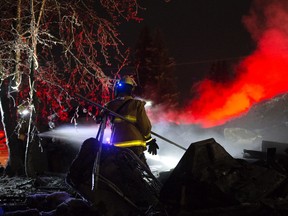 Firefighters return to the scene of a fatal house fire in the hamlet Rochford Bridge, Friday Dec. 6, 2019. firefighters were returning to dose hotspots at the home where earlier five people were found dead. Photo by David Bloom