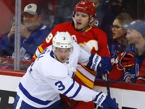 Calgary Flames Matthew Tkachuk battles Toronto Maple Justin Holl in second period action at the Scotiabank Saddledome in Calgary on December 12, 2019. Darren Makowichuk/Postmedia