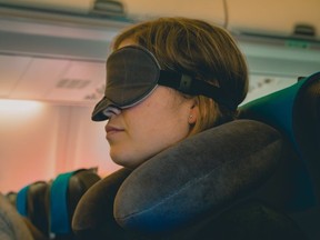 A neck pillow and eye mask can help you get some rest while flying.