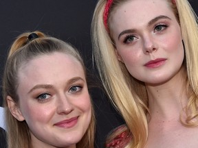 US actress Elle Fanning (R) and her sister actress Dakota Fanning arrive for the Los Angeles special screening of "Teen Spirit" at the Arclight on April 2, 2019 in Hollywood.