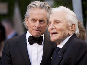 Michael Douglas, left, greets his father Kirk Douglas on the carpet as they arrive at the Vanity Fair Oscar Party, for the 84th Annual Academy Awards, at the Sunset Tower on Feb. 26, 2012 in West Hollywood, Calif. (ADRIAN SANCHEZ-GONZALEZ/AFP via Getty Images)
