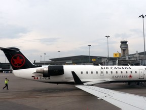 A pilot checks his Air Canada jet at at MontréalPierre Elliott Trudeau International Airport on June 1, 2018.