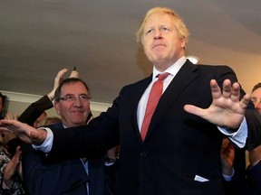 Britain's Prime Minister Boris Johnson gestures as he speaks to supporters on a visit to meet newly elected Conservative party MP for Sedgefield, Paul Howell, at Sedgefield Cricket Club in County Durham, north east England on December 14, 2019, following his Conservative party's general election victory.