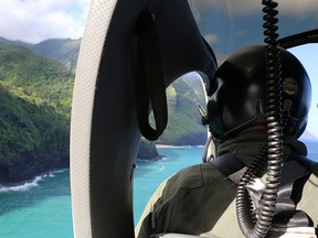 This photo provided by the Hawaii Department of Land and Natural Resources shows a Coast Guard search and rescue team looking over Napali Coast State Wilderness Park for a tour helicopter that disappeared in Hawaii with seven people aboard on Friday, Dec. 27, 2019.