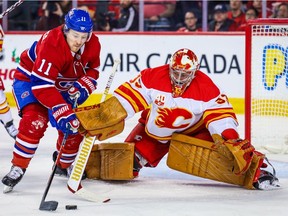 Calgary Flames goaltender David Rittich makes a save on the Montreal Canadiens' Brendan Gallagher during NHL game at the Scotiabank Saddledome on Dec. 19, 2019.