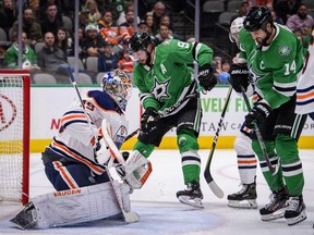 Edmonton Oilers goaltender Mikko Koskinen (19) defends against Dallas Stars left wing Jamie Benn (14) and center Tyler Seguin (91) during the second period at the American Airlines Center.