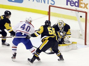 Canadiens winger Joel Armia scores his 11th goal of the season against Penguins goaltender Tristan Jarry as Pens defencemen John Marino, left, and Kris Letang defend Tuesday night at PPG Paints Arena in Pittsburgh.