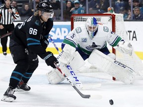 Vancouver Canucks goaltender Jacob Markstrom guards the net as San Jose Sharks right wing Joachim Blichfeld skates with the puck during the second period at SAP Center at San Jose.
