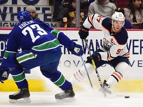 Edmonton Oilers forward Connor McDavid (97) controls the puck against Vancouver Canucks defenceman Alexander Edler during the second period at Rogers Arena in Vancouver on Dec. 23, 2019.