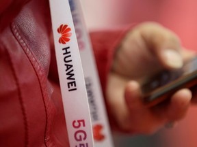 An attendee wears a badge strip with the logo of Huawei at the World 5G Exhibition in Beijing, China November 22, 2019.