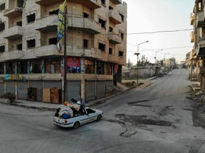 A drone picture shows a family as they flee with their belongings from Maaret al-Numan in Syria's southern Idlib governorate, on Dec. 23, 2019.