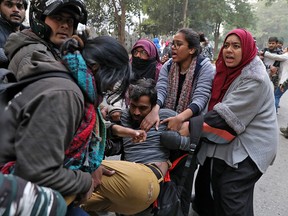 Demonstrators try to save a fellow demonstrator from being detained by police during a protest against a new citizenship law, in New Delhi, India, December 27, 2019. (REUTERS/Anushree Fadnavis)