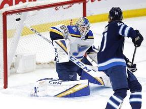 St. Louis Blues goaltender Jordan Binnington saves the shot by Winnipeg Jets' Kyle Connor Friday at Bell MTS Place.